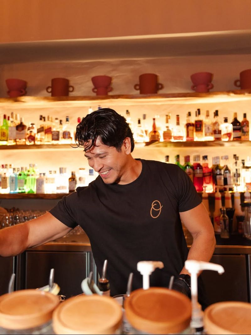 A smiling bartender at Oyana’s bar