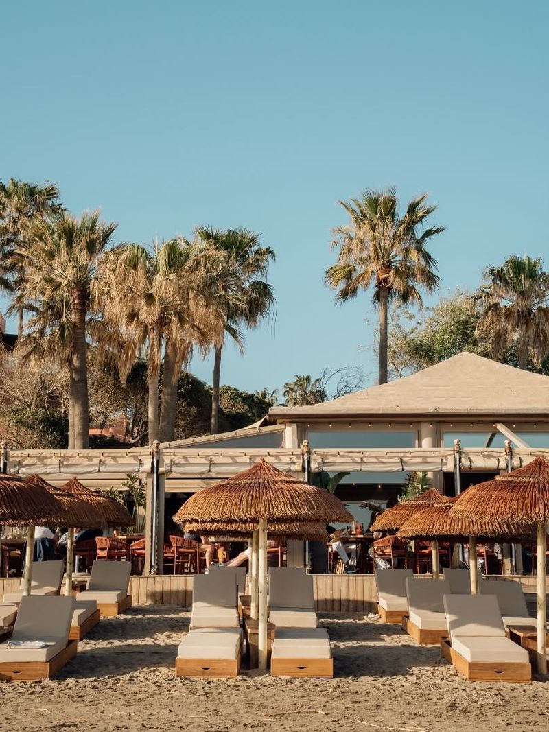 Oyana’s beach club: palms, the thatched canopy and lines of sunbeds on the sand